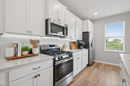 Gas Range, Quartz Countertops and Stainless Appliances