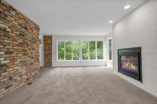 Main level sunroom with brick enhanced wall