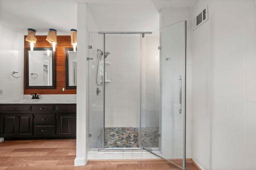 Primary shower with stone flooring