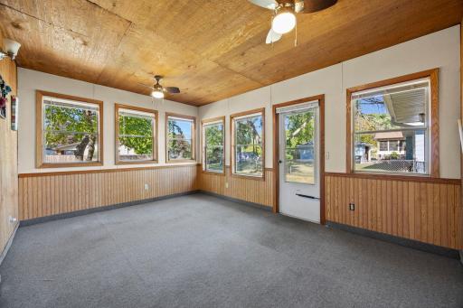 Main level sunroom off of the family room and overlooks the fenced backyard