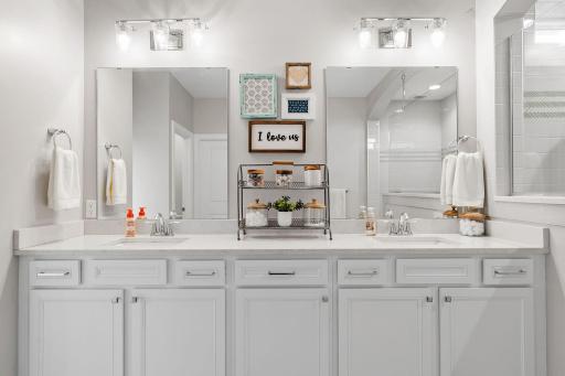 Primary Suite w/ dual walk-in closets + oversized tiled Serenity Shower