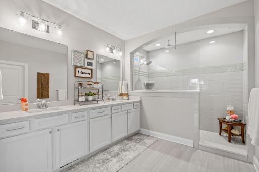 Primary Suite w/ dual walk-in closets + oversized tiled Serenity Shower