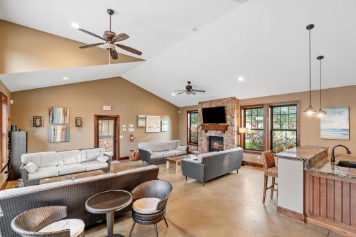 Clubhouse w/ full kitchen, fireplace, TV, bathroom & multiple entertaining spaces.