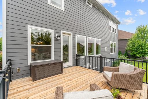 Walk out to the deck overlooking ample flat green space + beautiful pond views