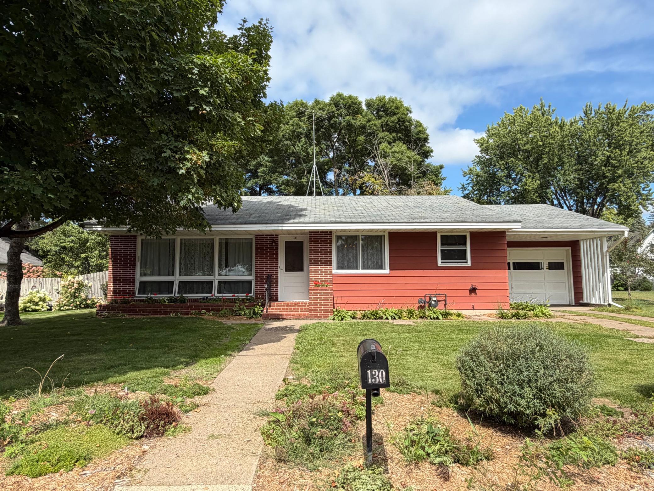 Front of home with attached large single car garage