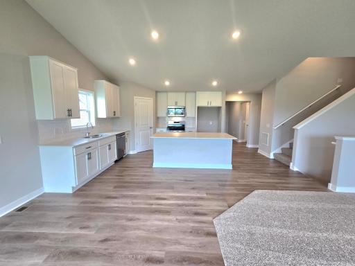 The Finnegan Kitchen shown with White cabinets at Highlands at Eagle View in Elko New Market. Photo is of similar home. Options and colors may vary. Ask Sales Agent for details.