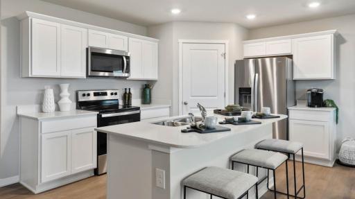 Harmony Modern Kitchen with island. Photos are of similar staged home. Colors and options may vary. Ask Sales Agent for details.