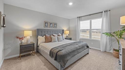 Large primary bedroom. King size bed. Photos are of similar staged home. Colors and options may vary. Ask Sales Agent for details.