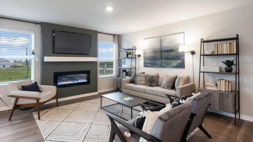 Harmony Living room with tv mounted on wall above electric fireplace. Photos are of similar staged home. Colors and options may vary. Ask Sales Agent for details.