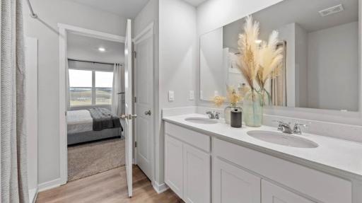 Large primary bedroom with double sinks. Photos are of similar staged home. Colors and options may vary. Ask Sales Agent for details.