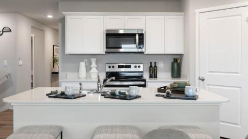 Harmony Modern Kitchen with island. Photos are of similar staged home. Colors and options may vary. Ask Sales Agent for details.
