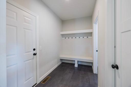 The convenient mudroom is located just off the garage, providing an easy transition into the home