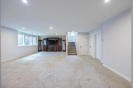The expansive lower-level family room offers plenty of space for entertaining, relaxing, and enjoying time with family and friends.