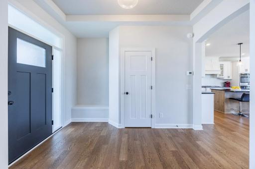 As you enter, you'll be welcomed by a spacious entryway featuring beautiful hardwood flooring.