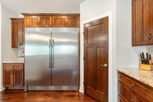 Double commercial style fridge and pantry next to it