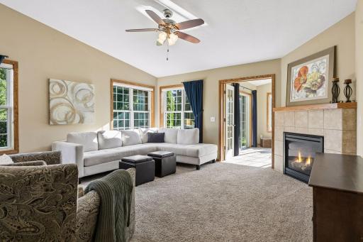 Living space features a cozy gas fireplace and is connected to a wonderful sunroom