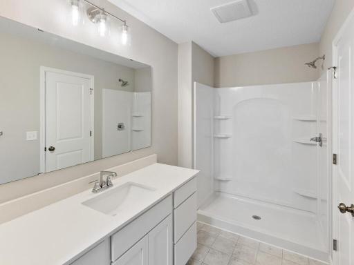 PHOTO OF A DIFFERENT HOME WITH SIMILAR PLAN & FINISHES. Plan and finishes may vary. Primary Suite Private Bathroom.