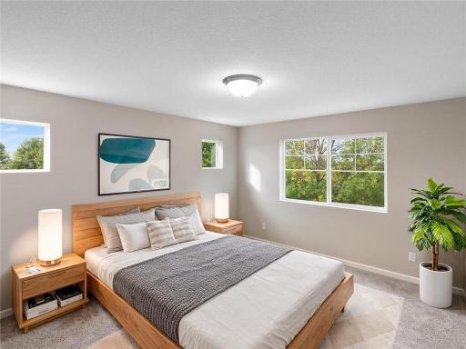 PHOTO OF A DIFFERENT HOME WITH SIMILAR PLAN & FINISHES. Plan and finishes may vary. Primary Suite.