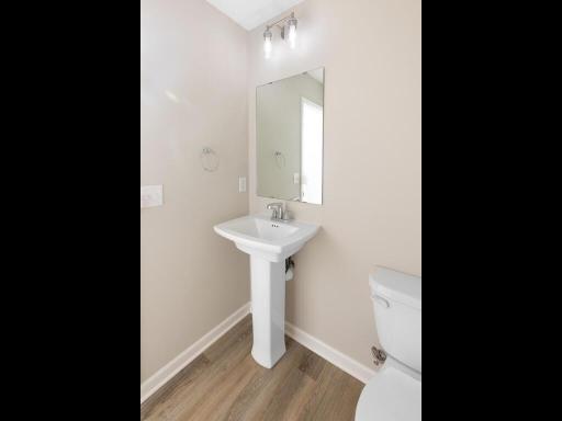PHOTO OF A DIFFERENT HOME WITH SIMILAR PLAN & FINISHES. Plan and finishes may vary. Main Floor Half Bath.