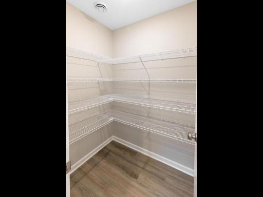 PHOTO OF A DIFFERENT HOME WITH SIMILAR PLAN & FINISHES. Plan and finishes may vary. Kitchen Walk-in Pantry.