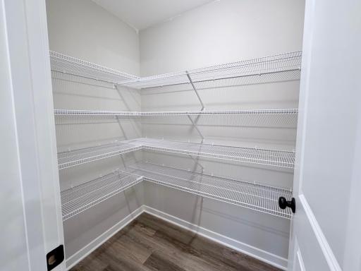 7077 Kittredge Lane NE - Photo of actual completed home. Kitchen features a Spacious Walk-in Pantry offering an abundance of storage!
