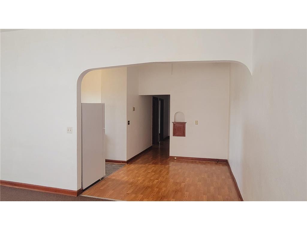 Distinctive Arched Pass-Through Leading to Kitchen and Dining