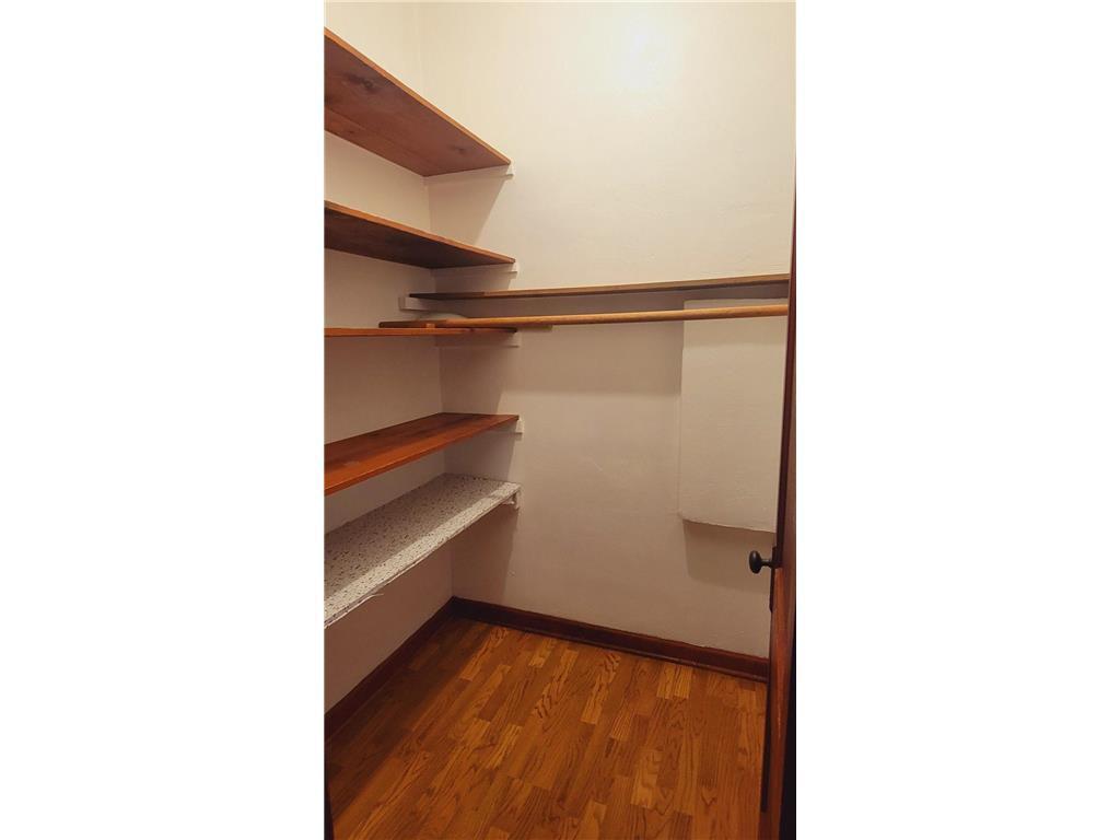 Versatile Walk-in Pantry or Linen Closet Offering Plentiful Built-in Storage