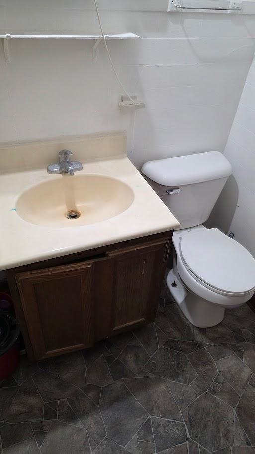 Unit 4: Powder Room with Ample Storage and Stone-Look Flooring