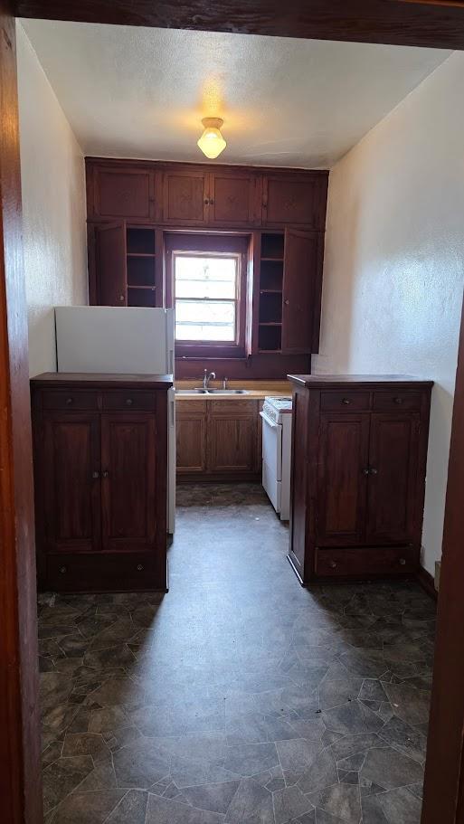 Unit 4: Galley Kitchen with Built-in Wood Cabinetry and Natural Light