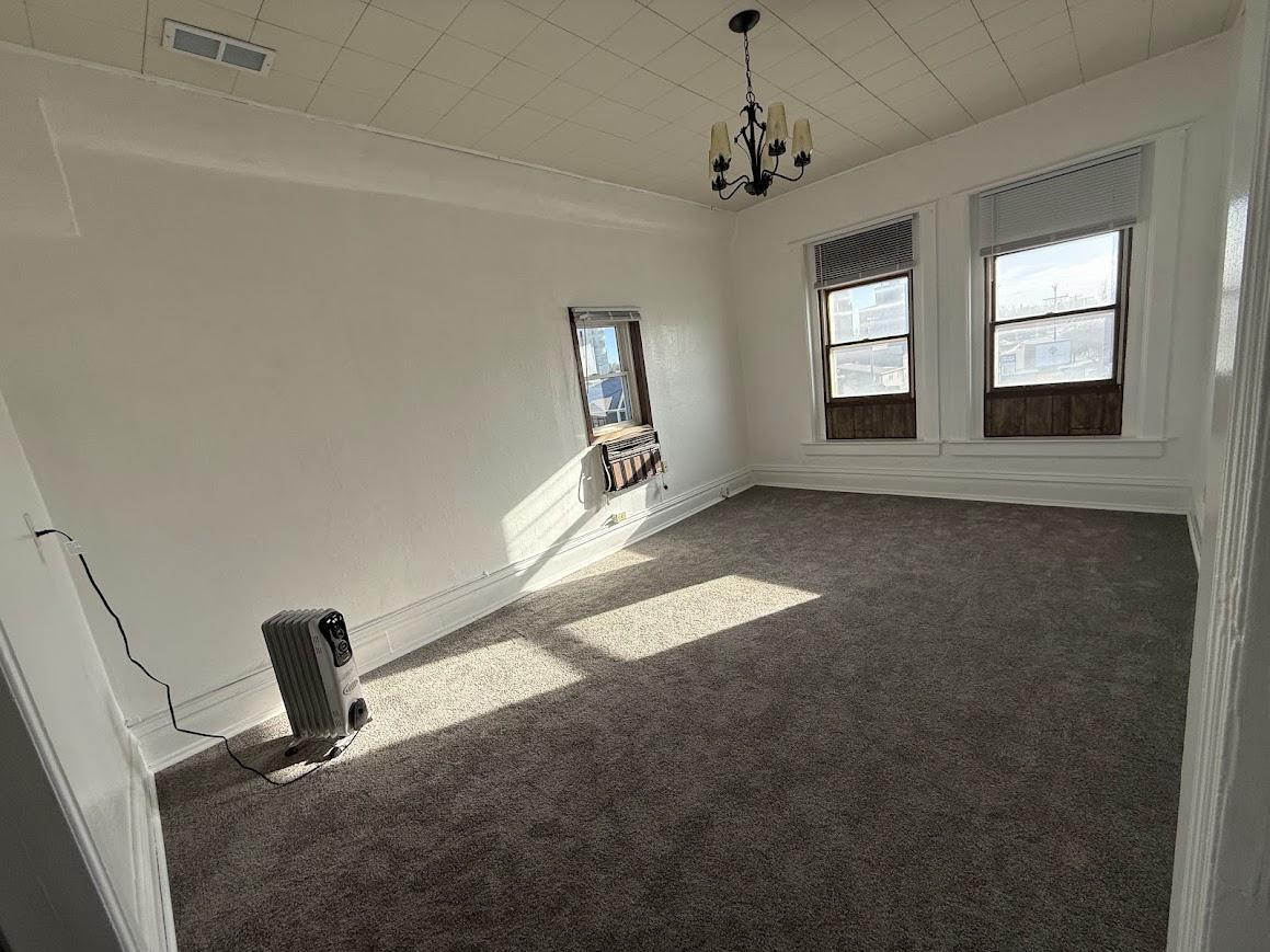 Unit 5: Expansive Living Space with Carpeted Flooring and Ample Daylight