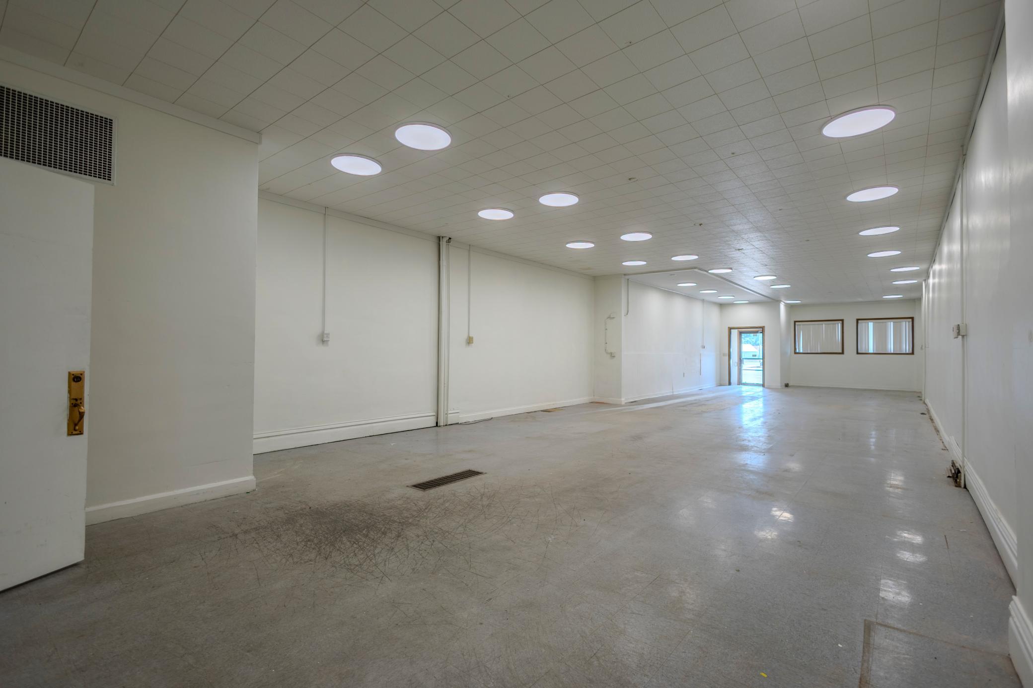 Large Open Floor Plan with Street Access and Modern Ceiling Fixtures