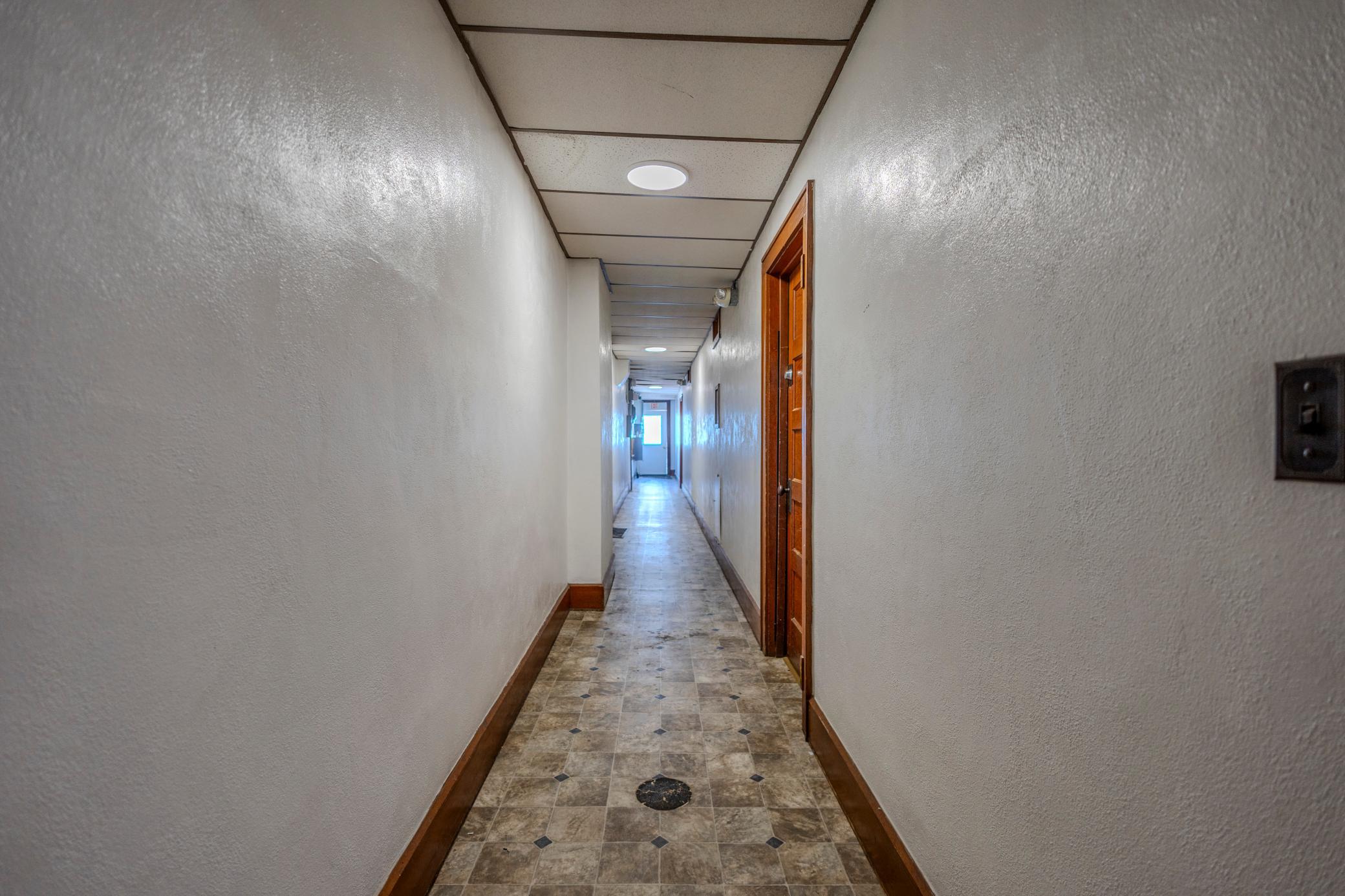 Well-Maintained Hallway Providing Access to Upper Suites