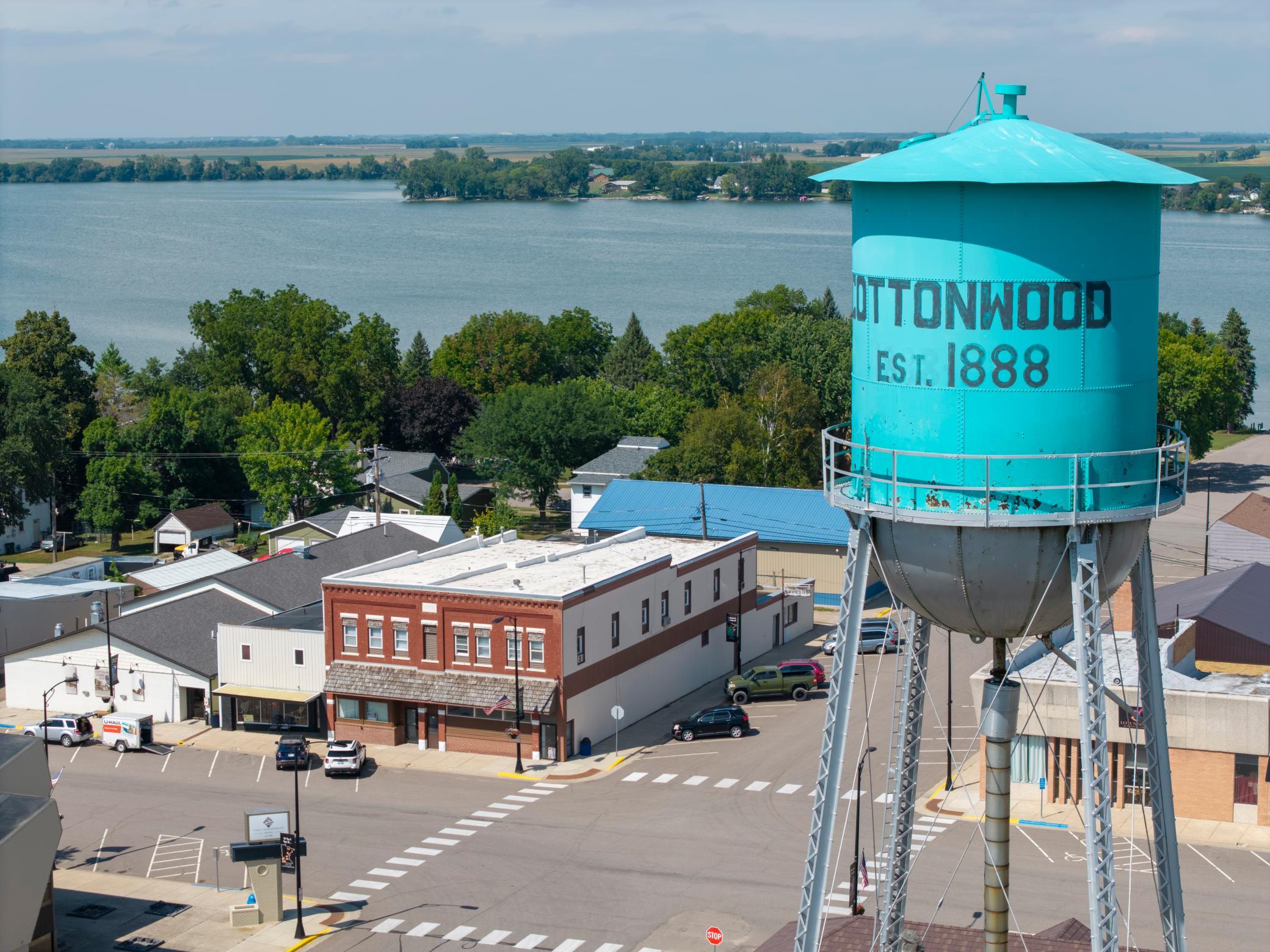 Prominent Main Street Commercial Building Framed by City Landmark & Lake