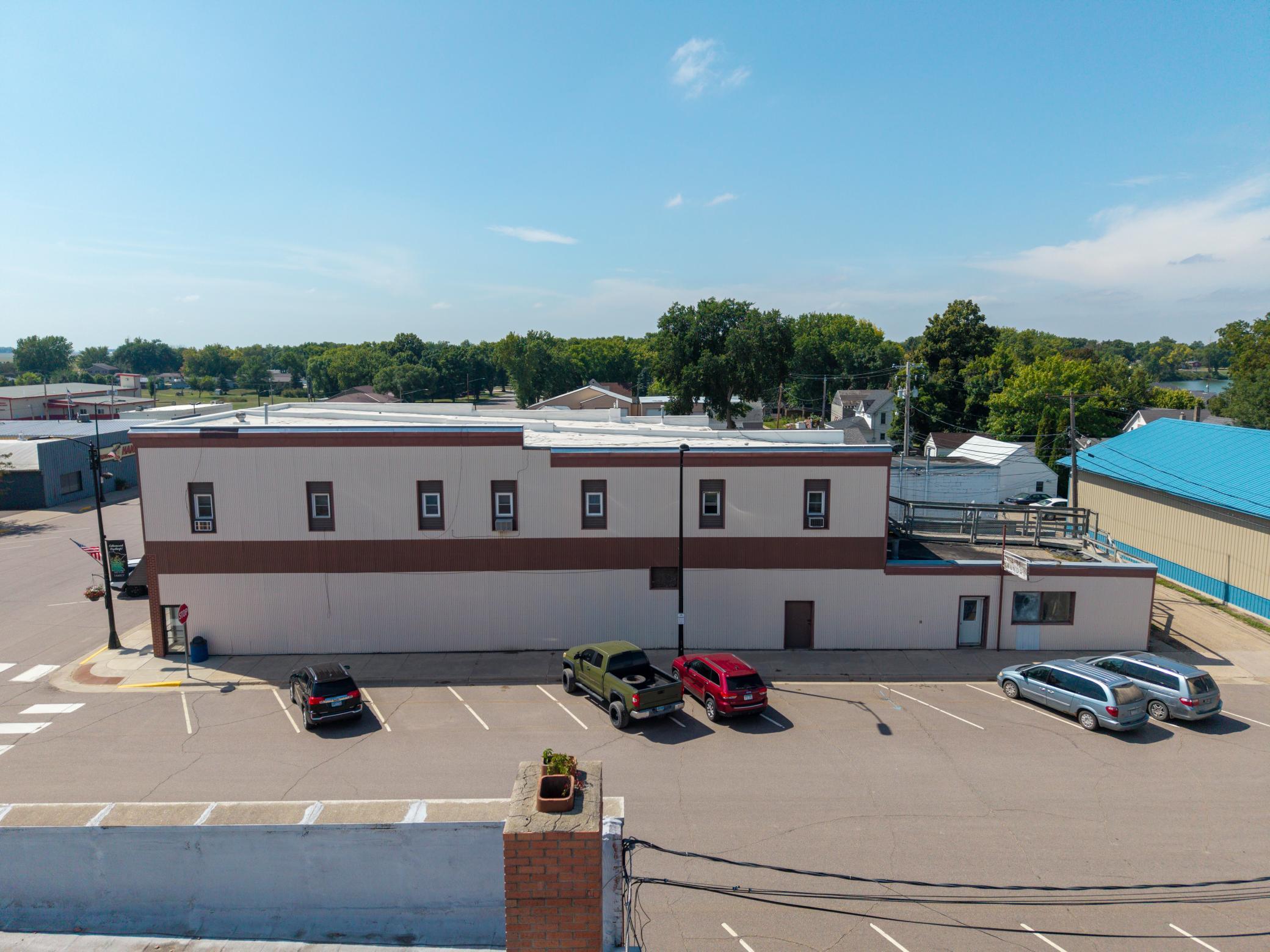 Overview of Commercial Building, Roofline, and Large Parking Lot