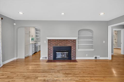 Brick fireplace and arched built-ins add character to the inviting living room.