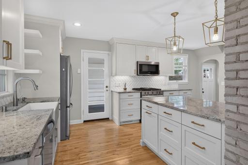 This Saint Louis Park home features an updated kitchen featuring granite countertops, abundant cabinetry and stylish finishes.