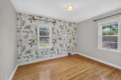 Second main-level bedroom offers hardwood floors and abundant natural light.