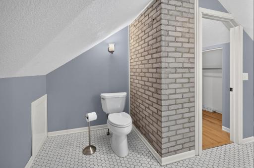 Spacious primary bath combines modern updates with charming architectural character.