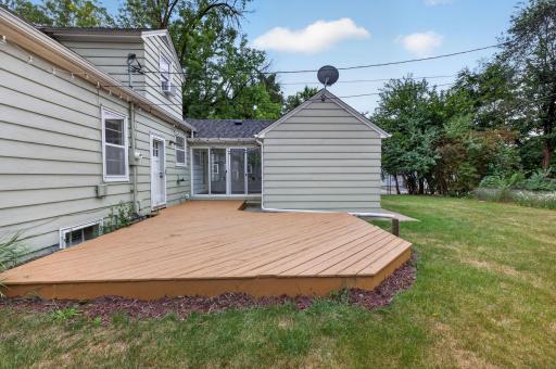 Large backyard deck creates an inviting space for outdoor dining and entertaining.