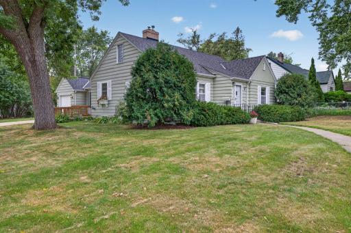 Classic exterior surrounded by mature trees and established landscaping.