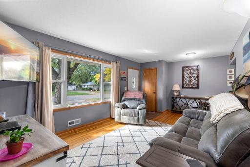 A large window adds abundant natural light and an inviting outdoor view to the main living space