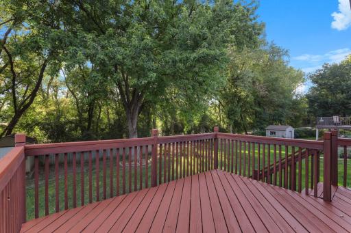 Recently re-stained deck overlooking the spacious backyard with mature trees and plenty of room to enjoy the outdoors.