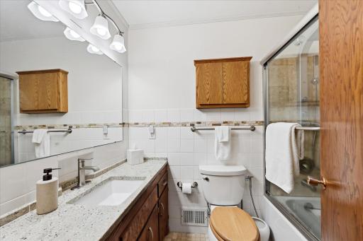 Quality updates can be found throughout the bathrooms, including new toilets, faucets, shower heads, sliding shower doors, and a replacement tub. The main bath features beautiful travertine tile and a durable hard-surface vanity countertop.