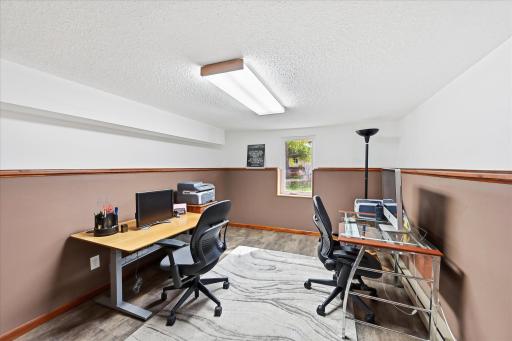 The lower-level third bedroom has been inspected and approved by the city, offering added functionality and confidence for future owners. Featuring updated vinyl flooring and an egress window, this room is currently used as a home office.