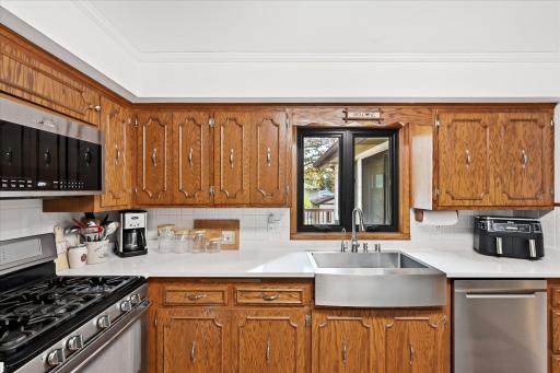 Recent kitchen improvements include updated flooring in 2023, countertops in 2024, a refrigerator installed in 2020, and a microwave added in 2026. The sink also features a motion-activated faucet for added convenience.