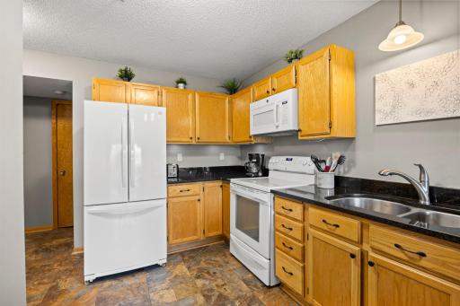 The kitchen lead to a hallway with access to the main level bathroom, utility room and garage area.