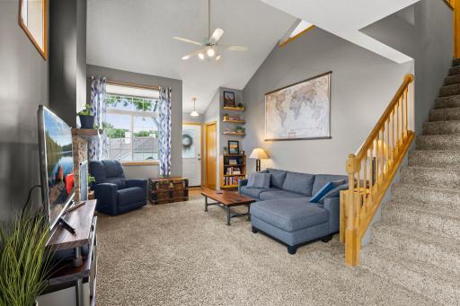 Main level living area leading to staircase that leads to the upper level.