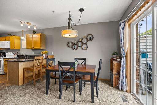 View of the main level dining area with sliding door outside access .