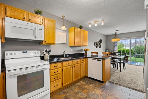 View form the kitchen through the dining room and out into the private patio space.