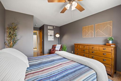Upper level primary bedroom featuring a walk in closet before the private bathroom